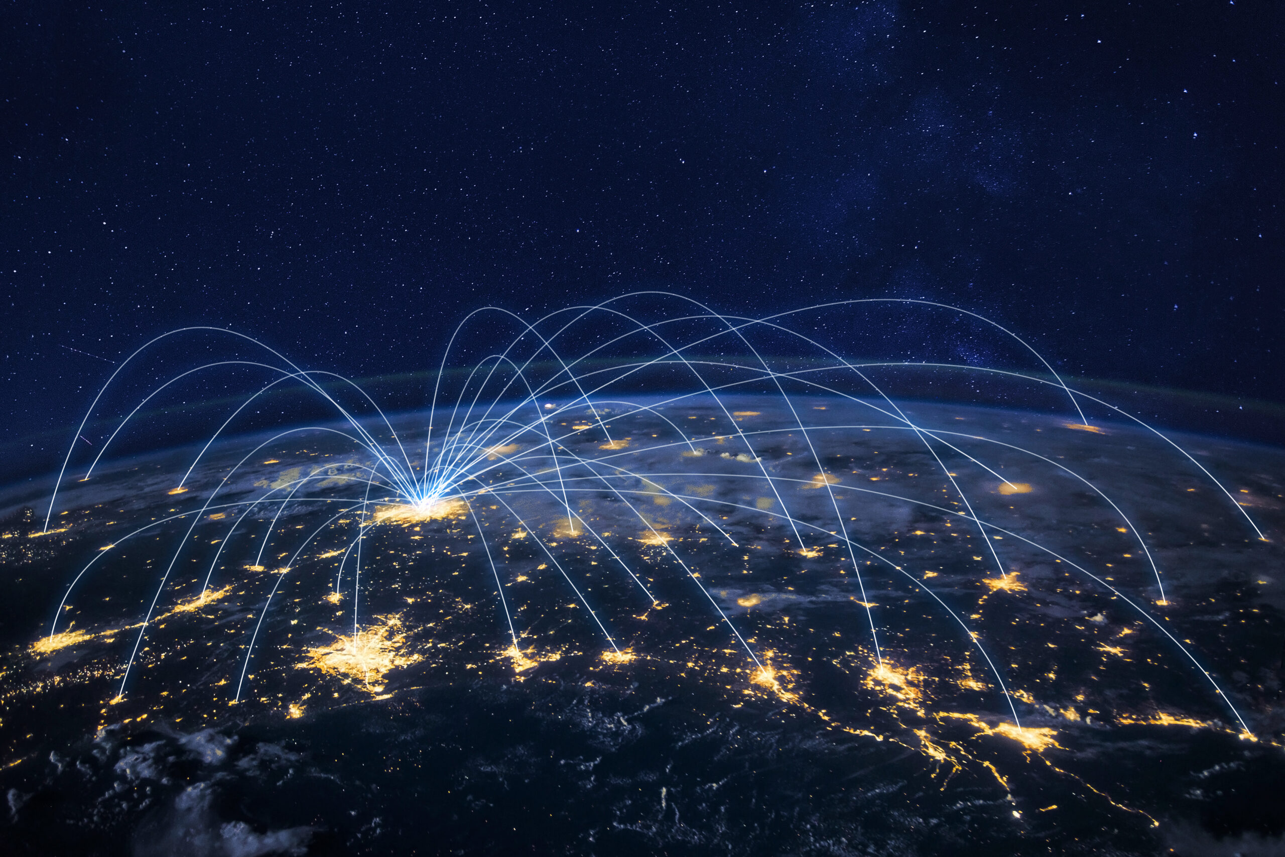 night time visual of the earth with beams of light as connections between a vast amount of cities across continents